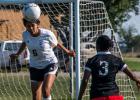 Niurka Tamayo (6) of Ranger (white) heads the ball away from her goal with Shanelle Henry (3) of Cisco ready to score