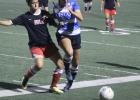  Battling with Hill defender is Sam Noughton (5) of the Lady Wranglers