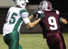 Caleb Gunstanson (9) tries to get away from the Wildcat tackler.