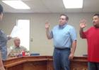 Elected school board members Joe Casey and Noah Landa take the Oath of Office administered by Terry Treadway.