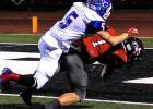 Josh Gosnell (1) drags a Bluecat with him as he scores for the Mavericks against Coleman.