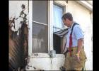 Firefighter examines damage